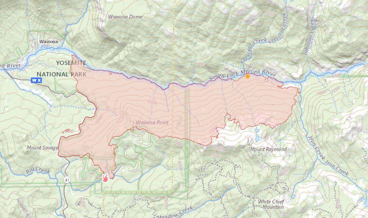 A topographic map shows the area encompassed by the Washburn Fire in Yosemite National Park and the Sierra National Forest on Monday, July 18, 2022. The starting point of the fire in the park’s Mariposa Grove is at lower left, and the community of Wawona is at upper left. The fire is growing to the east along the south fork of the Merced River, top, and toward Iron Creek, at right.