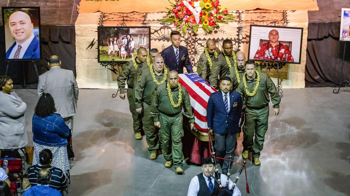 Fresno County Sheriff’s Office officer carry the body of correctional officer Toamalama Scanlan following a memorial service at the Save Mart Center in Fresno on Monday, Oct. 25, 2021.