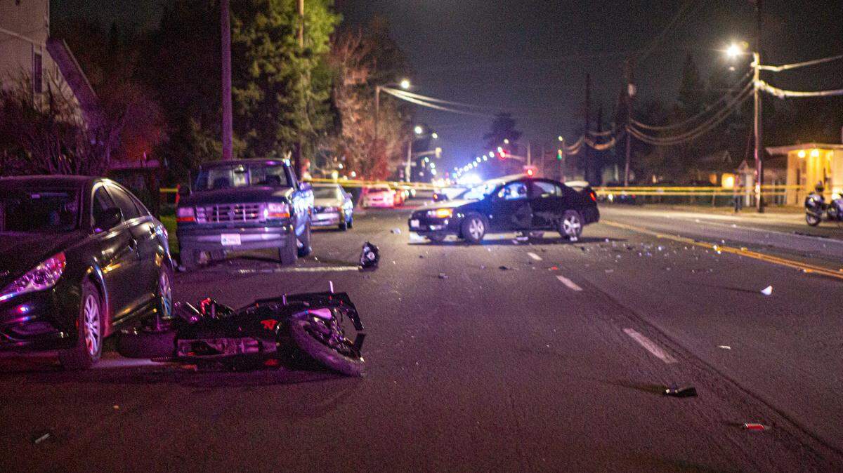 A smashed motorcycle sits in the roadway of Olive Avenue near 9th Street Sunday night, Feb 28, 2021, after a collision.