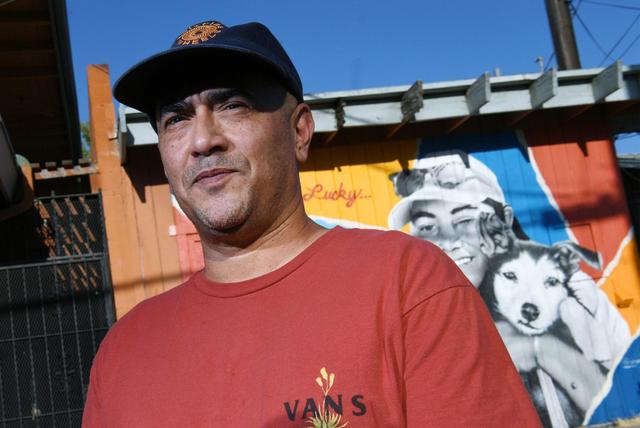 Mural artist Eric “Drane” Olage stands in front of the new mural honoring Monique Contreraz and her dog Lucky he created in the Tower District at Pine and Maria avenues. Contreraz was killed after being dragged 8 miles by a motorist earlier this year. Photographed Tuesday, July 26, 2022 in Fresno.