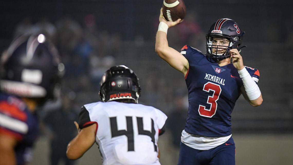 San Joaquin Memorial quarterback Mikey Bell throws against Hanford in the first half of their game at San Joaquin Memorial on Friday, Aug. 27, 2021. The game was later suspended due to poor air quality.