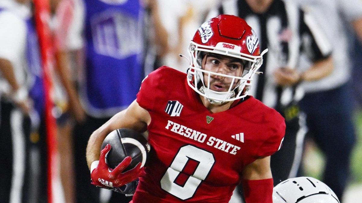 Fresno State wideout Mac Dalena run outruns Kent State’s Bryce Sheppert, right, in the Bulldogs’ 53-10 victory over Kent State Saturday, Sept. 23, 2023 in Fresno.
