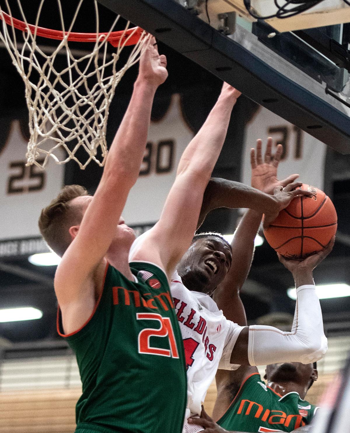 Fresno State guard Braxton Huggins, right, draws contact from  Miami forward Sam Waardenburg on his way to the basket in the Bulldogs’ 78-76 loss to the Miami Hurricanes at the Wooden Legacy tournament Friday, Nov. 23, 2018, in Fullerton. Huggins hit 10 of 21 shots in scoring a career-high 28 points for the 2-2 Bulldogs.
