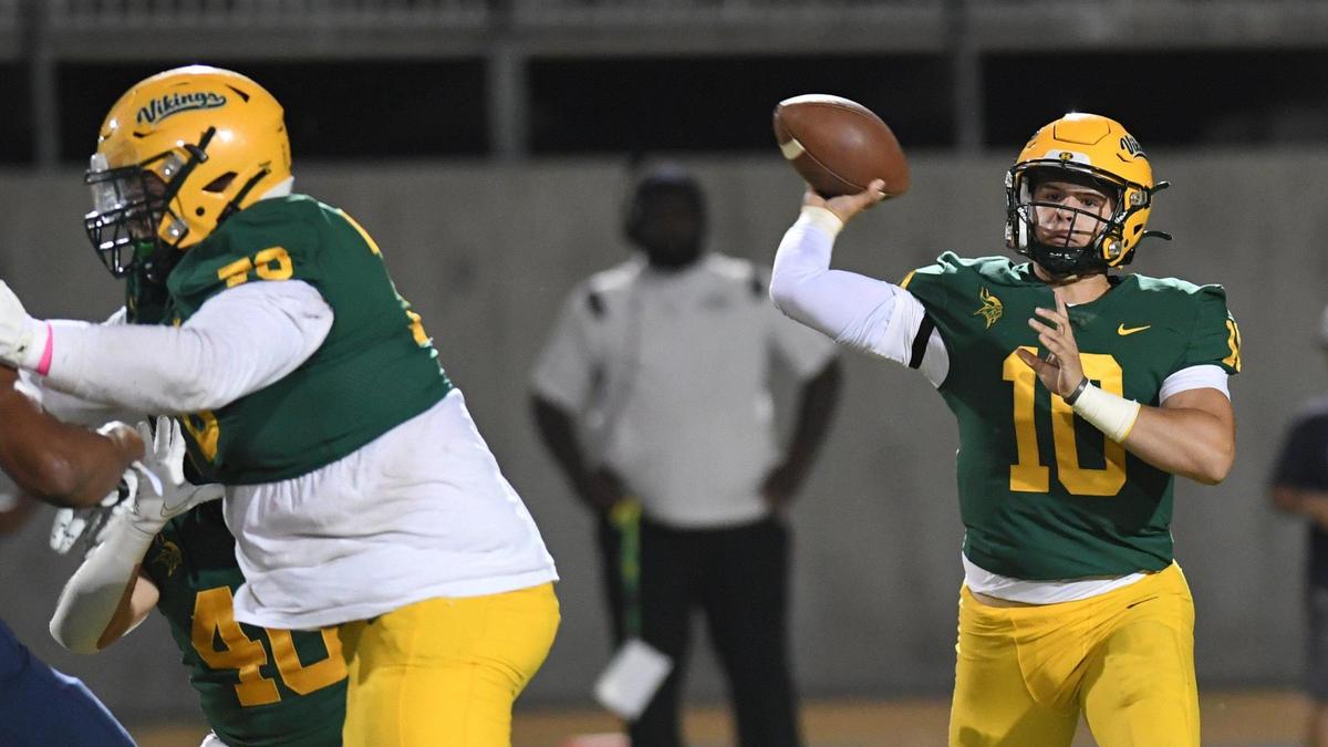 Kingsburg quarterback Ethan Winslow, right, throws while getting protection form the line during their game against Central Valley Christian at Kingsburg on Friday, Oct. 14, 2022.