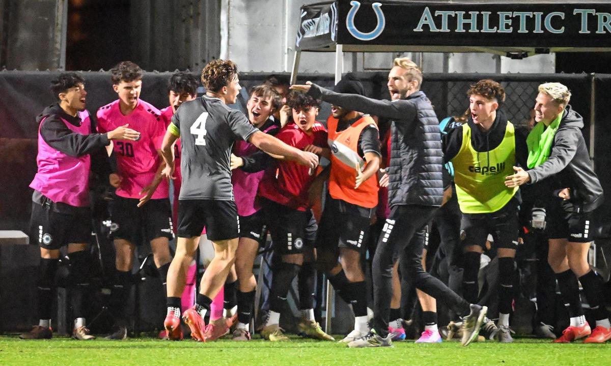 Clovis North’s Josh Gault is congratulated by teammates after scoring the tying goal in the first half of their Division 1 soccer final against Edison on Thursday, Feb. 27, 2025.