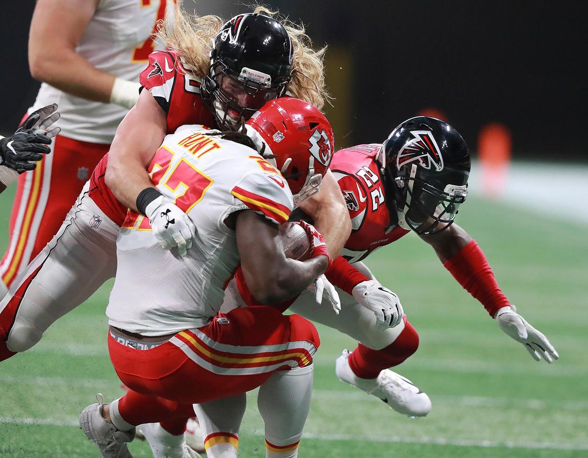 Atlanta Falcons safety Keanu Neal, right, and defensive end Brooks Reed tackle Kansas City Chiefs running back Kareem Hunt during the first quarter of an NFL preseason game in Atlanta. Neal was penalized for lowering his head to initiate contact on the play.