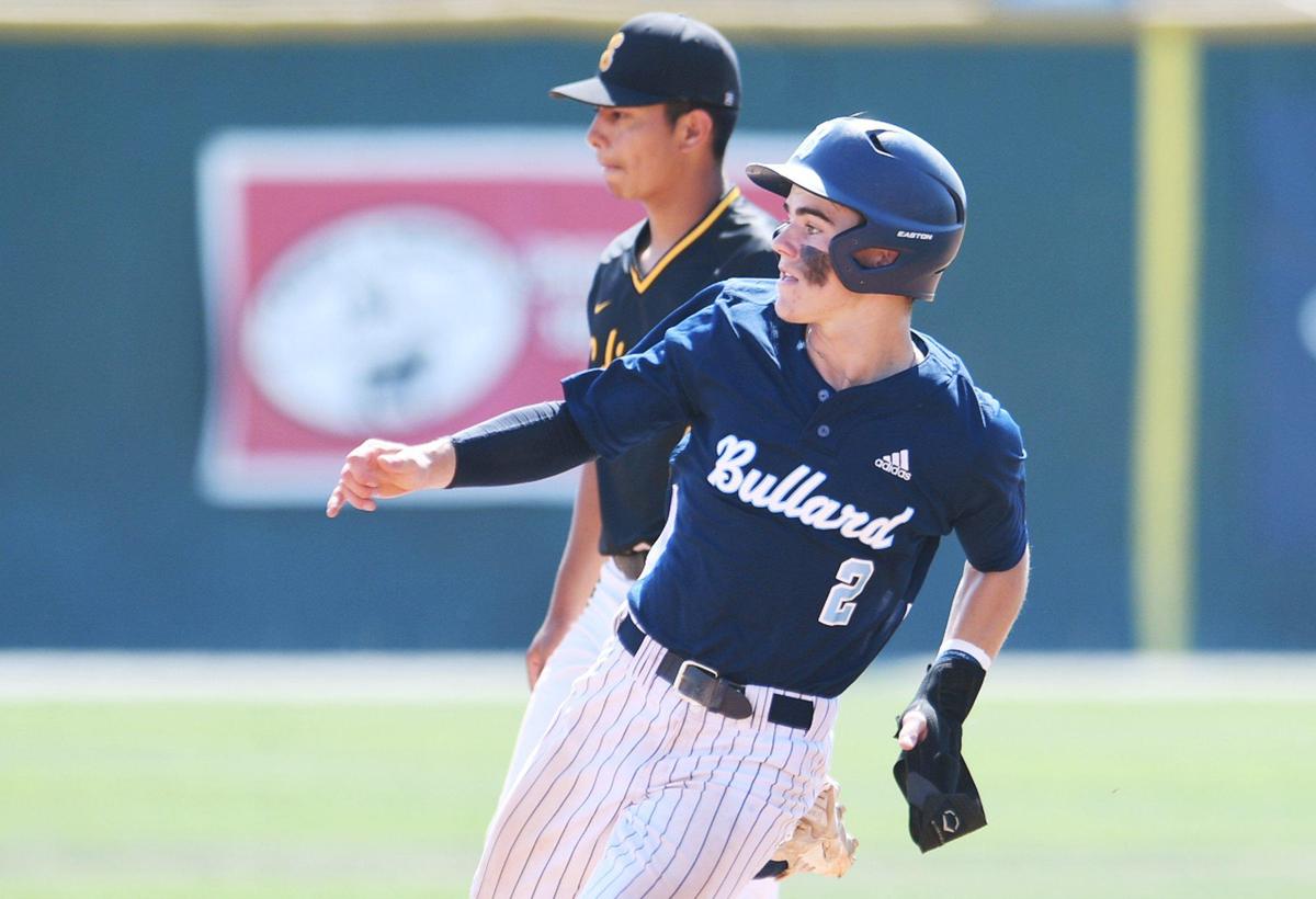 Bullard’s Beckett Zavorek, foreground, rounds second base on a double by Mark Baca as the Knights defeated the Tigers 2-0 in a County/Metro Athletic Conference baseball game Saturday, March 26, 2022 in Fresno.