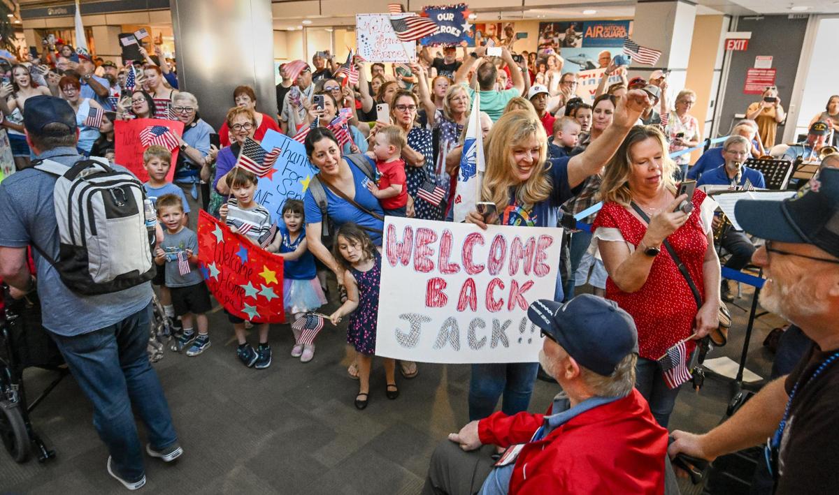 Hundreds of welcomers wave and cheer as veterans from the Central Valley Honor Flight arrive back at Fresno Yosemite International Airport after touring U.S. Capital monuments and memorials on Wednesday, May 17, 2023.
