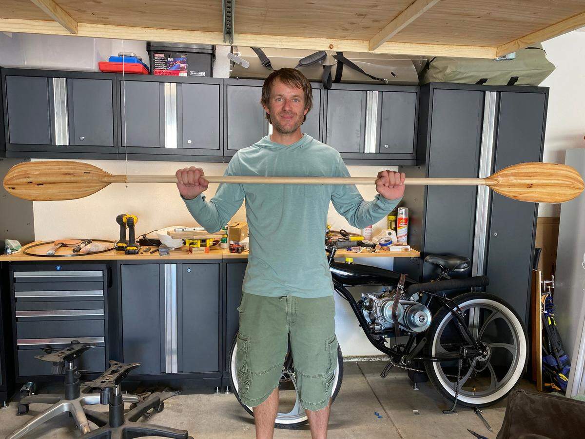 Nicholas Torchia holding a paddle he made.