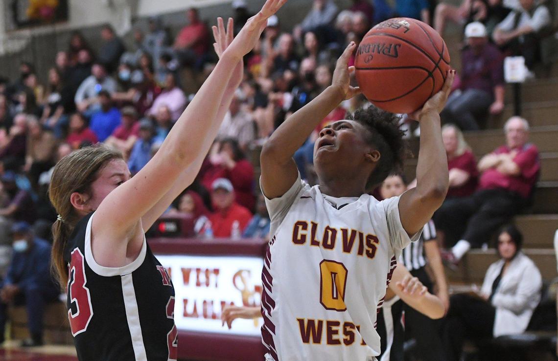 Clovis West’s Athena Tomlinson, right, is fouled by Nipomo’s Kacie Slover, left, in Open Division action Saturday, Feb. 19, 2022 in Fresno. Clovis West toppled Nipomo 68-18.