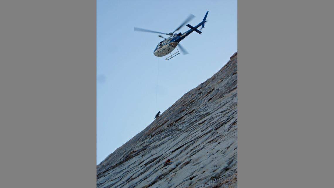 FRESNO COUNTY SHERIFF’S OFFICE - In this 2012 photo, a helicopter and Fresno County Sheriff’s search and rescue team member rescue a Santa Barbara man from a rocky ledge on Dog Tooth Peak in the Sierra Nevada.