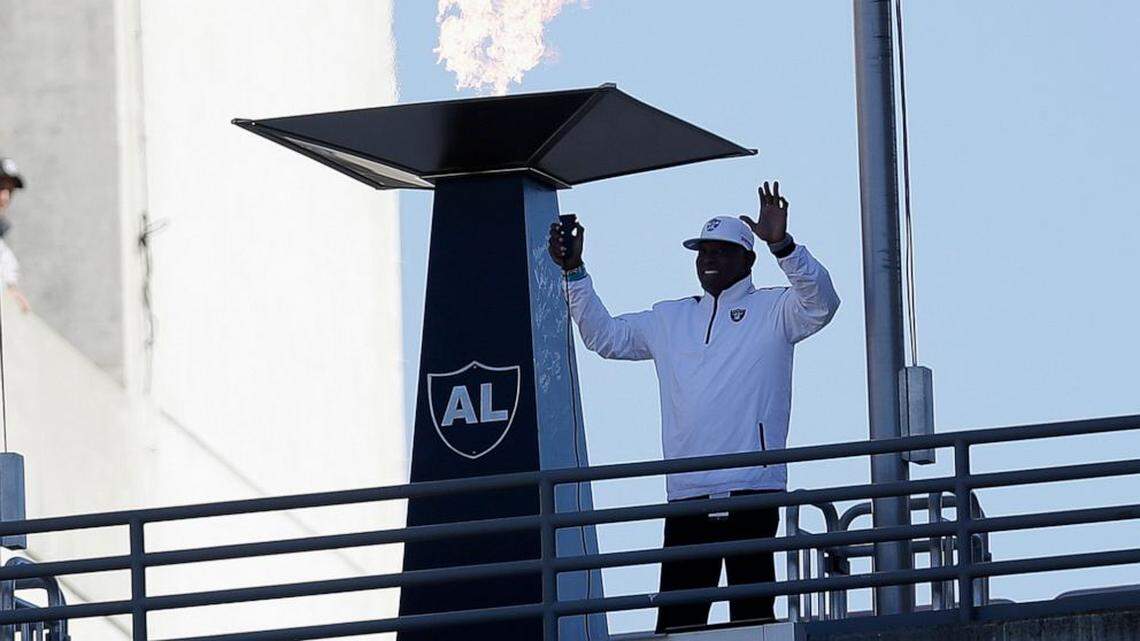 FILE - In this Nov. 4, 2012, file photo former Oakland Raiders wide receiver Cliff Branch lights a ceremonial torch for former Raiders owner Al Davis before an NFL football game between the Oakland Raiders and the Tampa Bay Buccaneers in Oakland, Calif. Branch, one of the Raiders’ career-leading receivers who won three Super Bowls.