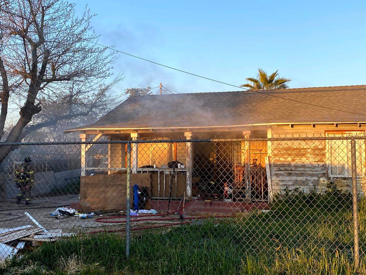 Fresno firefighters work on an attic fire in a home on 11th Street near Floradora Avenue about 6:45 a.m. Friday, Feb. 25, 2022.