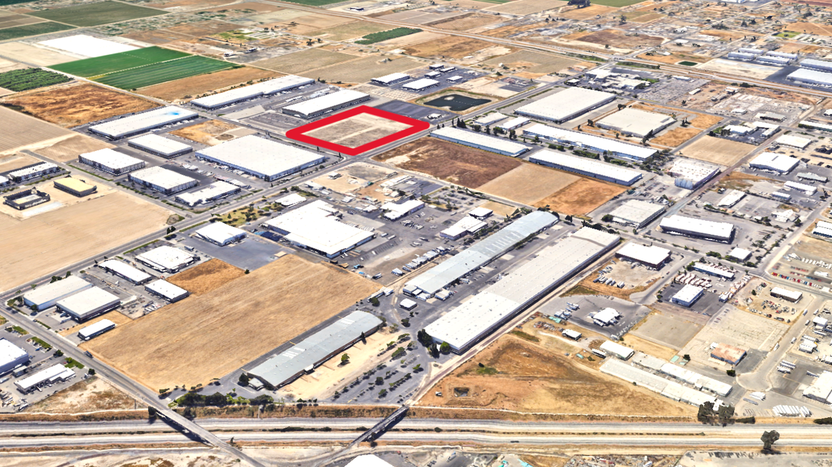 In this aerial Google Earth view of south Fresno, looking southwest from Highway 99 and Orange Avenue in the foreground, the 14.8-acre site for a proposed warehouse for Reyes Coca Cola Bottling LLC is highlighted within a red boundary. The Fresno City Council will consider approving the project at its meeting on March 30, 2023.