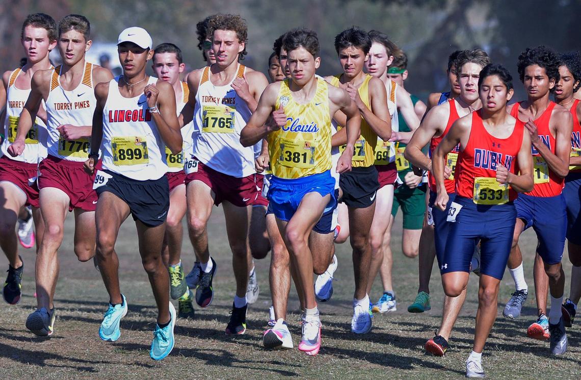 Clovis High’s Christopher Caudillo, center, runs in the Division I race at the CIF State Cross Country Championships on Saturday, Nov. 27, 2021, at Woodward Park in Fresno.