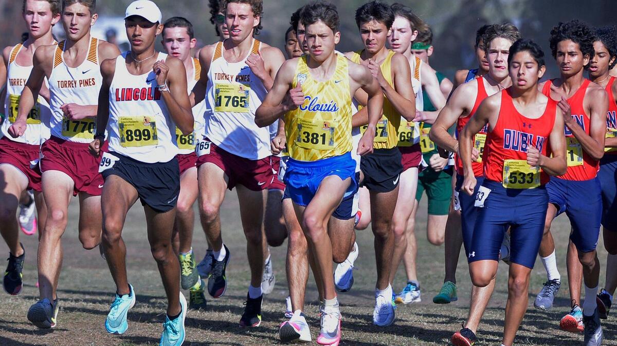 Clovis High’s Christopher Caudillo, center, runs in the Division I race at the CIF state cross country championships held at Woodward Park Saturday, Nov. 27, 2021 in Fresno.