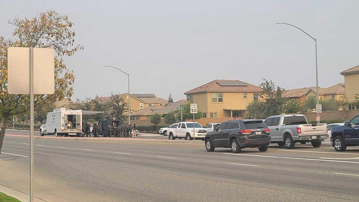Fresno police SWAT team members gather near Maple and Copper avenues on Monday, Aug. 16, 2021, during negotiations to end a standoff with a man suspected of a robbery and carjacking.