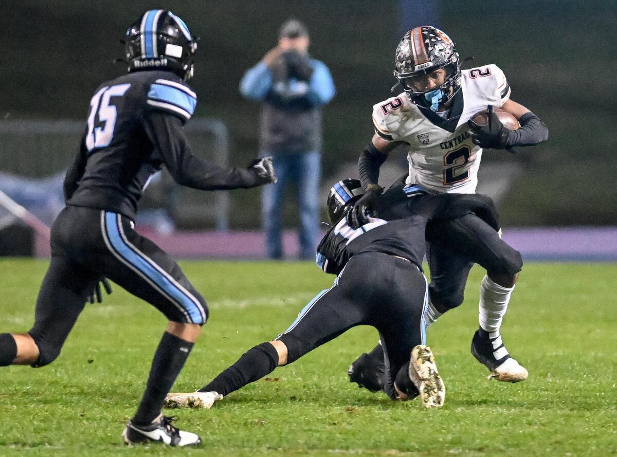 Central’s Brandon Smith gets tackled by Clovis North’s Trent Rogers in their Central Section Division 1 football championship game at Veterans Memorial Stadium in Clovis on Friday, Nov. 24, 2023.