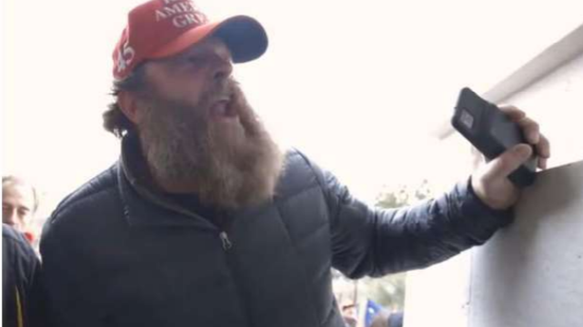 A scene prosecutors say is from a YouTube video and shows Benjamin Martin at the U.S. Capitol on Jan. 6, 2021, was included in a charging document.