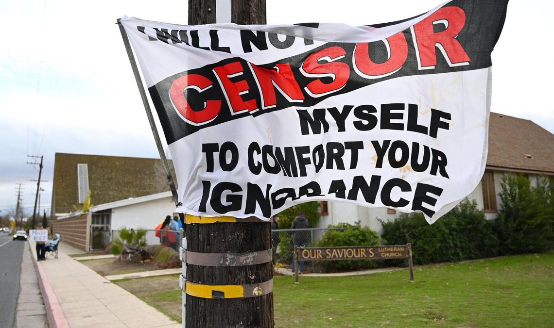 A flag is posted to a pole protesting the Fresno Drag Fest being held at Our Saviour’s Lutheran Church Saturday, Dec. 10, 2022 in Fresno.