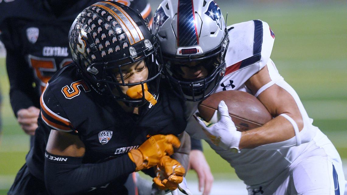 Central’s Kaleb Tennison, left, hits Liberty-Bakersfield wide receiver Austin Pratt, right, in the Central Section Division I championship Friday, Nov. 26, 2021 in Fresno.