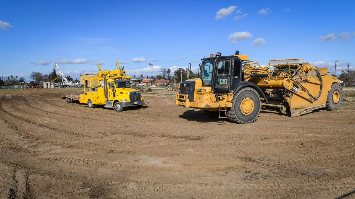 An earth mover and other heavy equipment sits in a construction area during a groundbreaking ceremony for the Landmark Square project in Clovis on Tuesday, Feb. 16, 2021. Landmark Square is the future location of a new senior activity center, transit center, and public library at 3rd Street and Veterans Avenue near Old Town Clovis. The Smittcamp family of Clovis donated $1 million toward the senior activity center, which will bear their family name. The nearly 29,000 square foot facility will feature a conference hall, rooms for enrichment classes, and a health clinic run by Saint Agnes Medical Center.