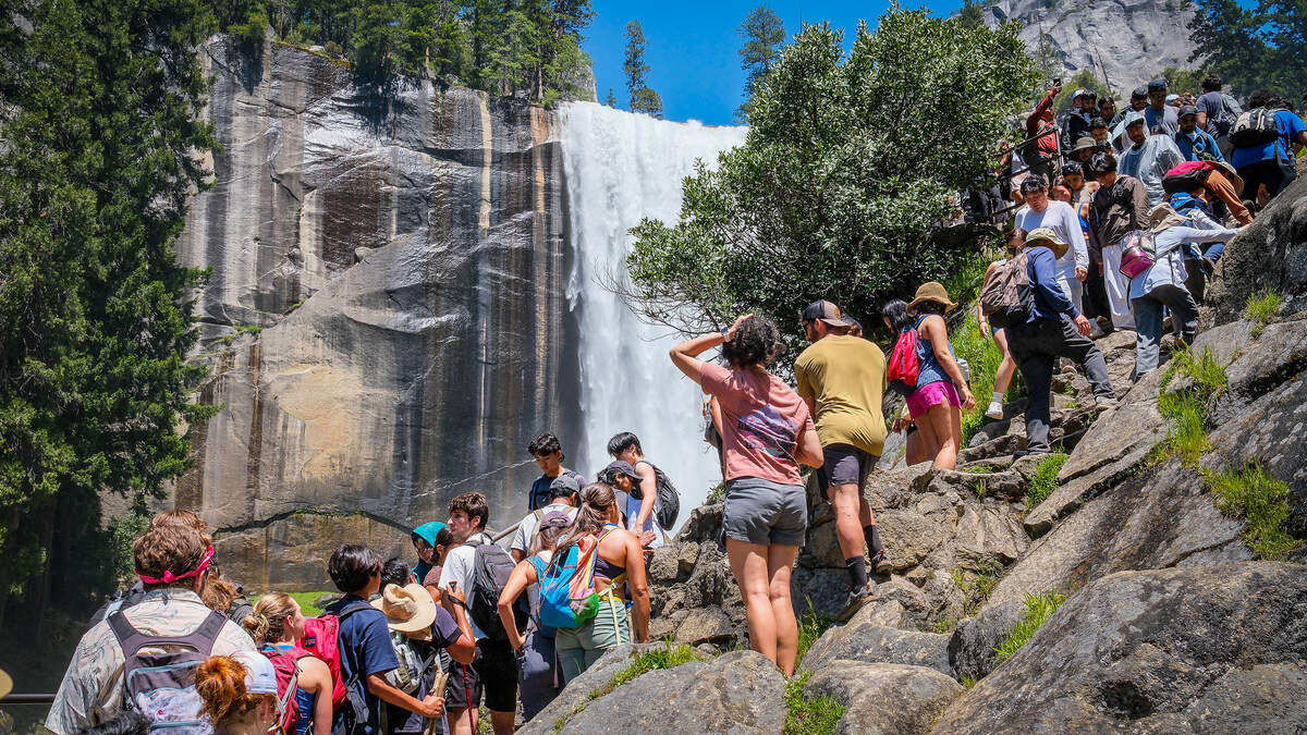 Hikers crowd together to get a view of Vernal Fall on Yosemite National Park’s Mist Trail on a busy Memorial Day weekend, Saturday, May 23, 2026.