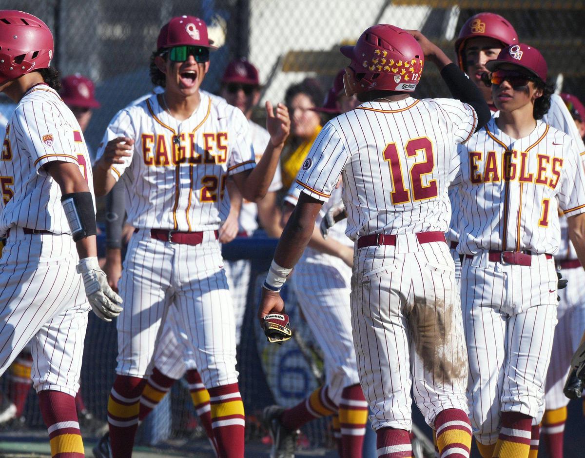 Clovis West’s Luke Raygoza, center, cheers Kaleb Latimer’s run in the 2nd inning against Memorial in Coca Cola Classic baseball championship action Saturday, March 12, 2022 in Clovis. Clovis West ended the game defeating Memorial 9-2 in six innings for the championship.
