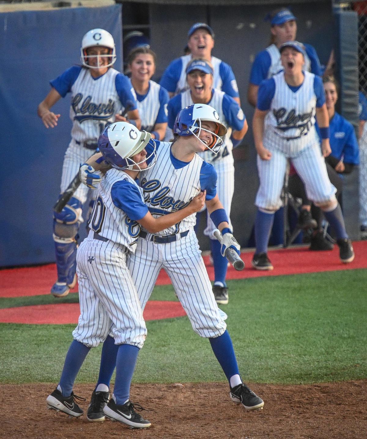 Clovis’ Ashley Rocha, left, celebrates scoring a run with teammate Brooke Brazill during their Central Section Division I softball championship game against Central at Margie Wright Diamond on Saturday, May 28, 2022.