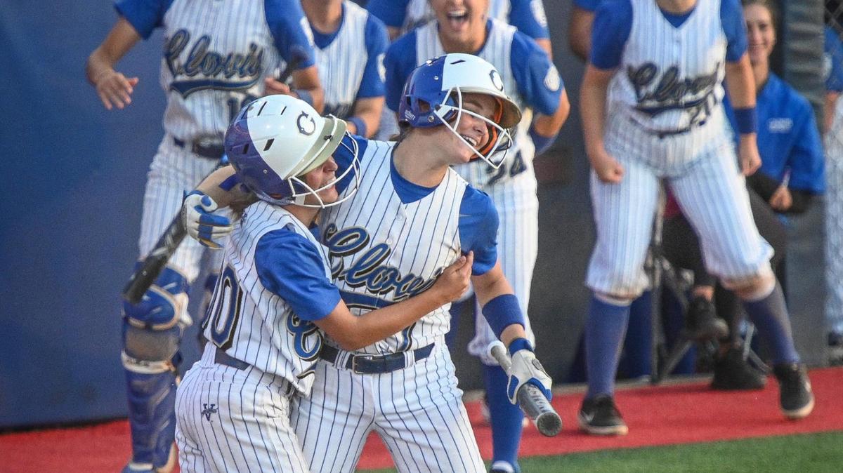 Clovis’ Ashley Rocha, left, celebrates scoring a run with teammate Brooke Brazill during their Central Section Division I softball championship game against Central at Margie Wright Diamond on Saturday, May 28, 2022.