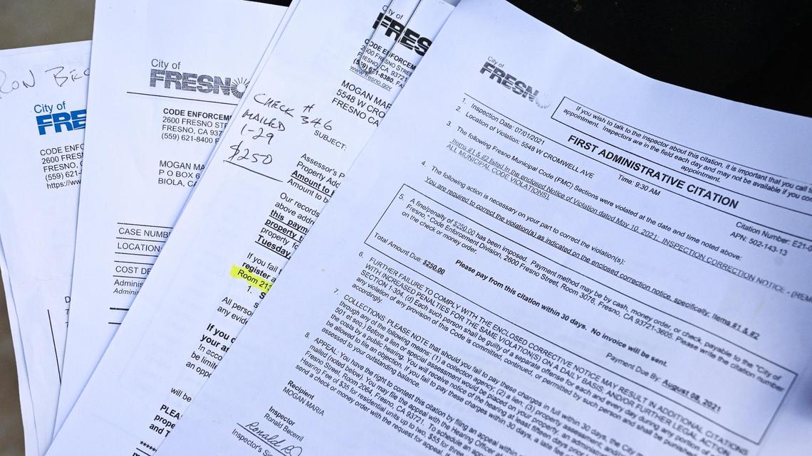 Citations and notices from the City of Fresno’s code enforcement sent to Maria Morgan with fines totaling nearly $1,000 due to address numerals covered up by a palm bush.