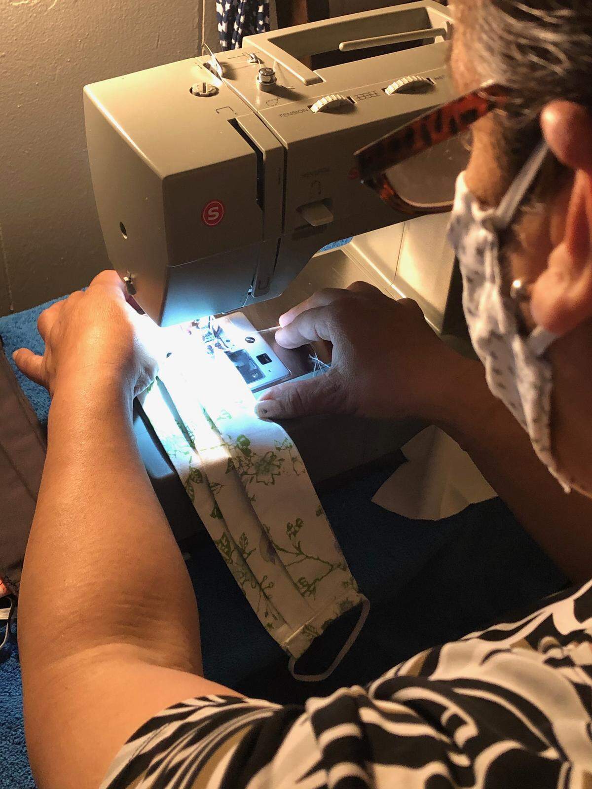 Maria Camacho sews face masks at her home in Delano, California. The farmworker mother has been out of work since the coronavirus pandemic has spread in the central San Joaquin Valley.