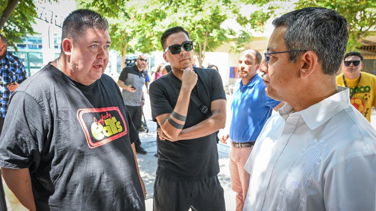 Fresno Street Eats president Mike Osegueda, left, talks with Fresno City Councilmember Miguel Arias after Arias announced a city-enforced pause in outdoor vendor operation at the Aug. 1 ArtHop, during a news conference at Kern Plaza in downtown Fresno on Friday, July 19, 2024.