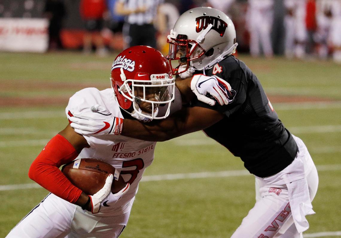 Fresno State wideout KeeSean Johnson tries to evade a tackle by UNLV Rebels defensive back Alex Perry (4) in the Bulldogs’ 48-3 victory at Sam Boyd Stadium in Las Vegas Saturday, Nov. 3, 2018. Johnson led Fresno State with eight receptions for 97 yards.