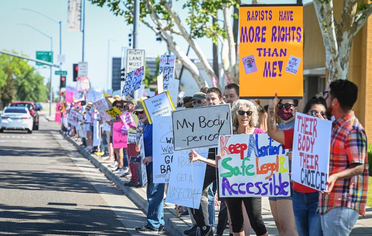 Hundreds line Blackstone Avenue at Nees in front of the River Park shopping center in Fresno during a rally in support of Roe v. Wade on Saturday, May 14, 2022.
