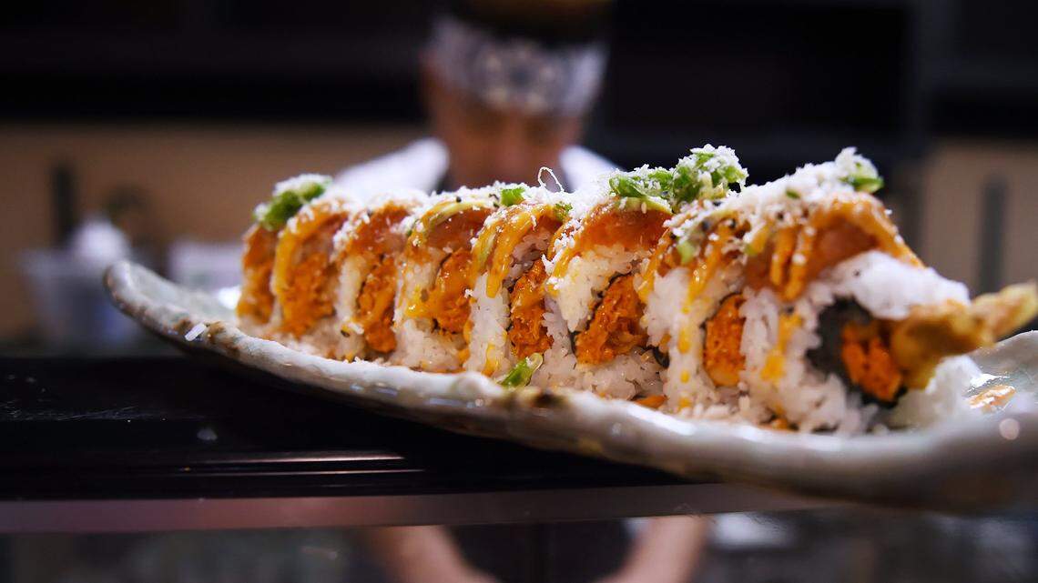 Sushi chef and manager John Chang, background, prepared the Dynamite Roll, which consists of spicy crab, shrimp tempura, spicy tuna, and avocado at Shobu Japanese Cuisine. The restaurant, pictured in this file photo from 2020, is on Blackstone Avenue near Herndon Avenue in Fresno.