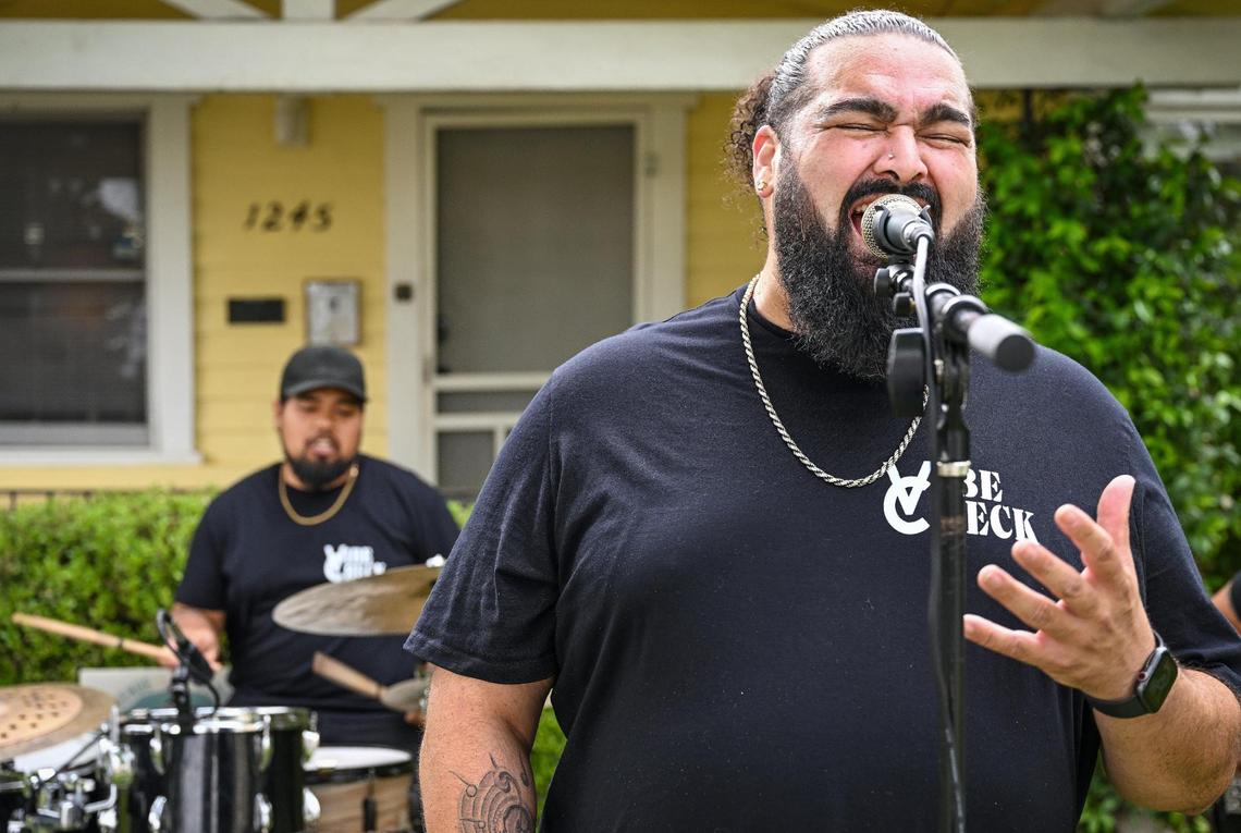 Ralph Edwards sings while Gene Abella backs him up on drums while they perform with Vibe Check during a rehearsal in front of a home in Fresno’s Tower District in preparation for this year’s Tower Porchfest, on Thursday, April 17, 2025.