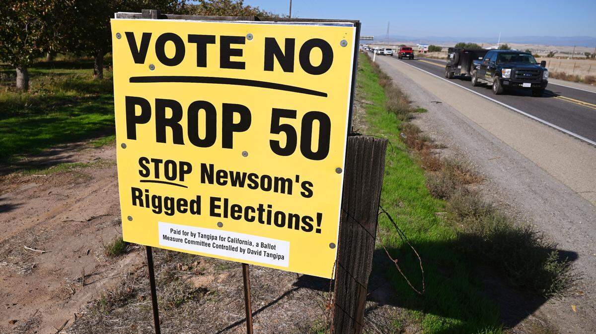 Southbound traffic passes a Vote No On Prop. 50 sign along Highway 41 near Avenue 12 Tuesday, Oct. 28, 2025 just north of Fresno.