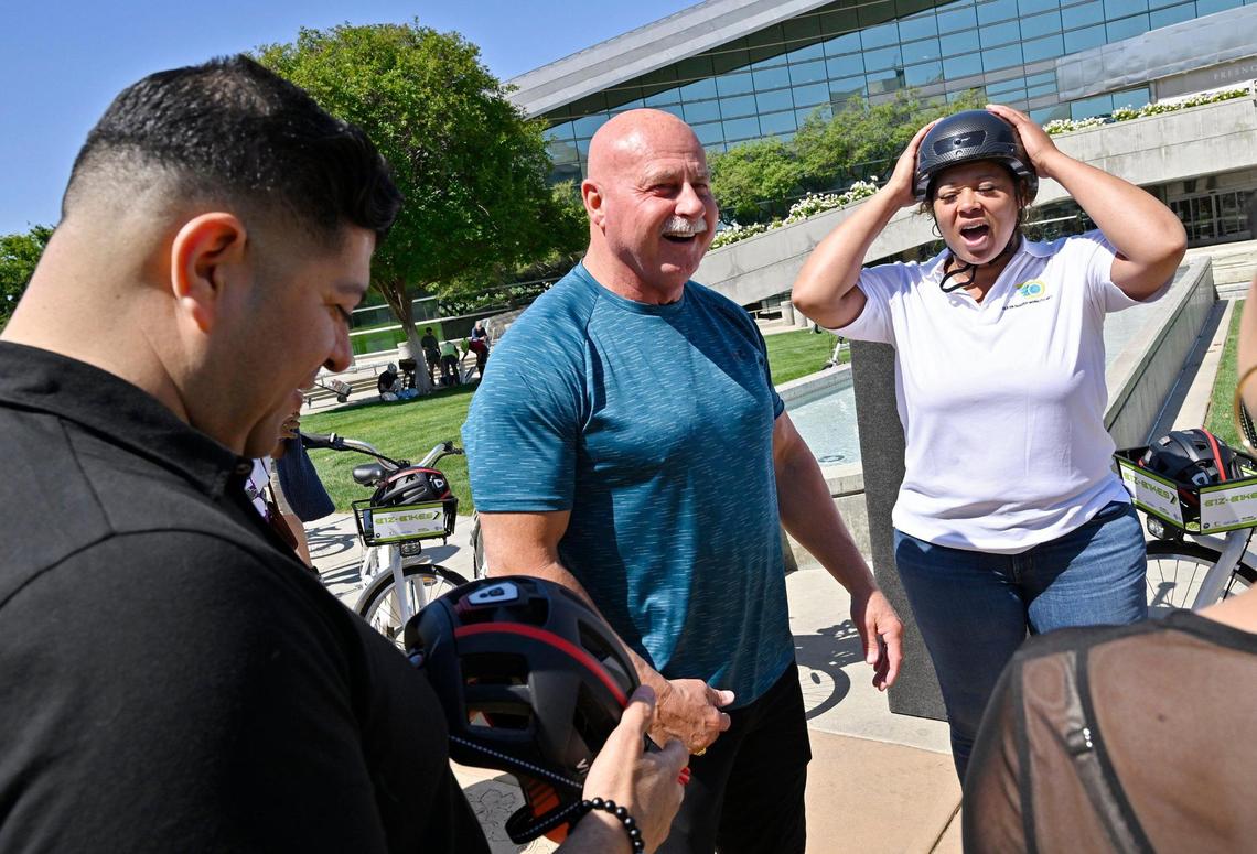 Councilmember Luis Chavez, left, and FUSD board member Keshia Thomas, right, prepare for a bike ride with Fresno Mayor Jerry Dyer, center, to help kickstart May as Bike Month, Wednesday, May 10, 2023 in Fresno.