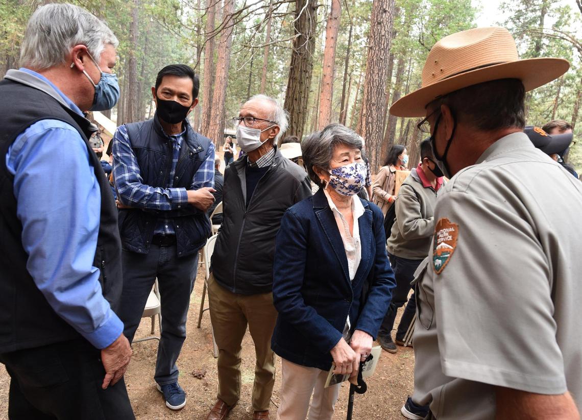 Franklin Yee, center in gray jacket, talks with Frank Dean, President of Yosemite Conservancy, left, as his wife Sandra Yee, talks with Scott Gediman, Yosemite Park Public Information Officer, after dedication ceremonies of the 1917 Chinese laundry building at Wawona, Friday, Oct. 1, 2021. The Yees, of Sacramento, were principal donors in the renovation project. The building, principally was used to service the Wawona Hotel, was also used in various purposes over the years and is being rededicated to tell the story of Chinese American contributions to Yosemite’s history.