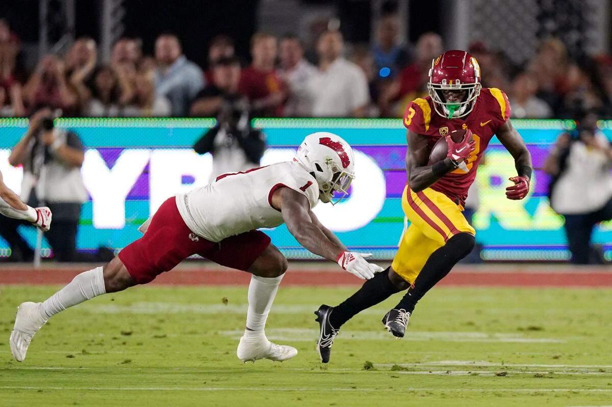 Southern California wide receiver Jordan Addison, right, runs the ball as Fresno State linebacker Raymond Scott attempts a tackle during the first half of an NCAA college football game Saturday, Sept. 17, 2022, in Los Angeles. (AP Photo/Mark J. Terrill)