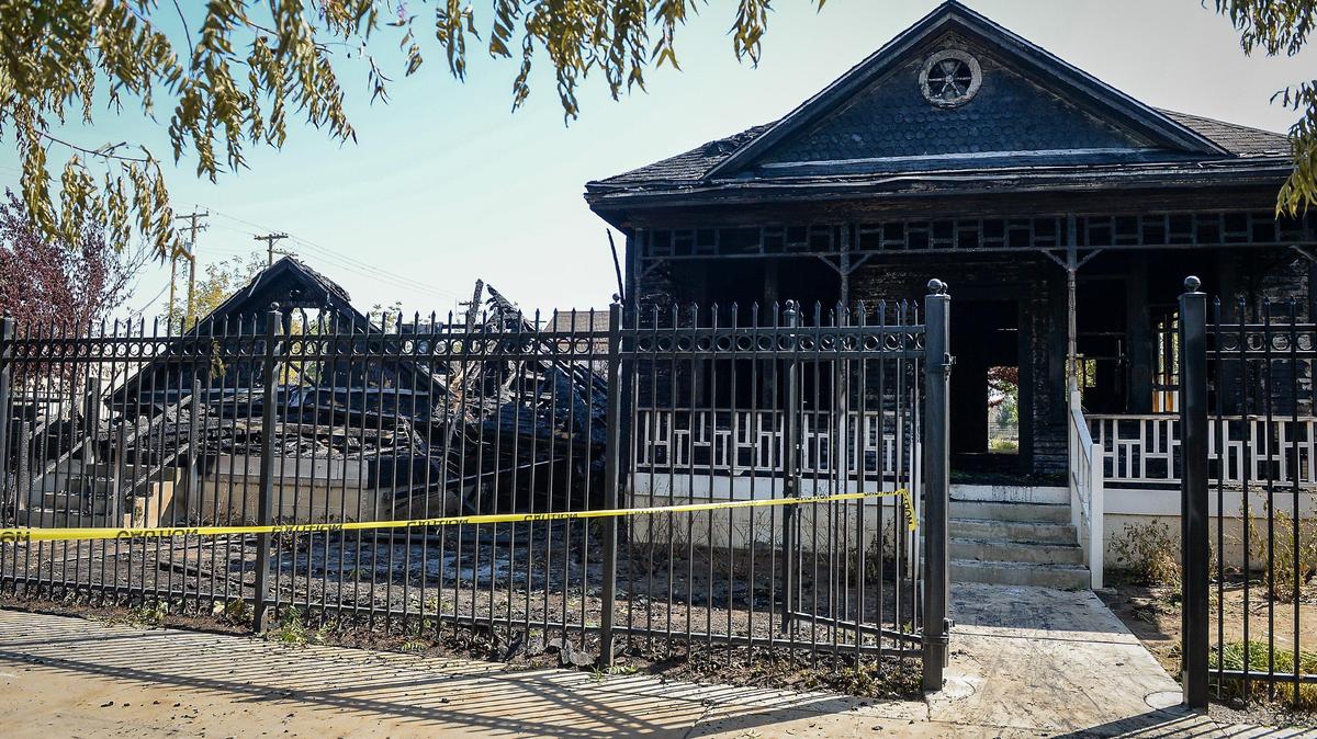 A home in the historic Old Armenia Town area of Fresno is shown destroyed by fire while another is badly damaged after a pre-dawn blaze burned through the area on June 4, 2020.