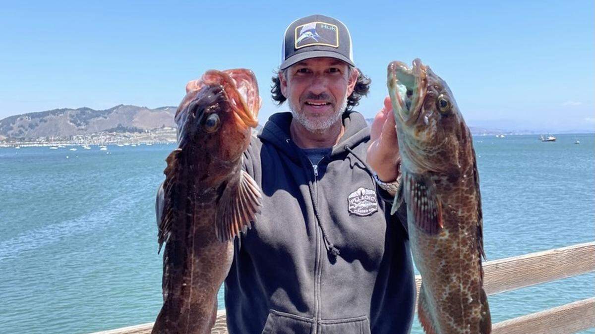 Jason Bailey of Visalia holds a pair of lingcod that he caught back-to-back on his boat after launching out of the Port San Luis Sport Launch/Avila Beach on July 29.