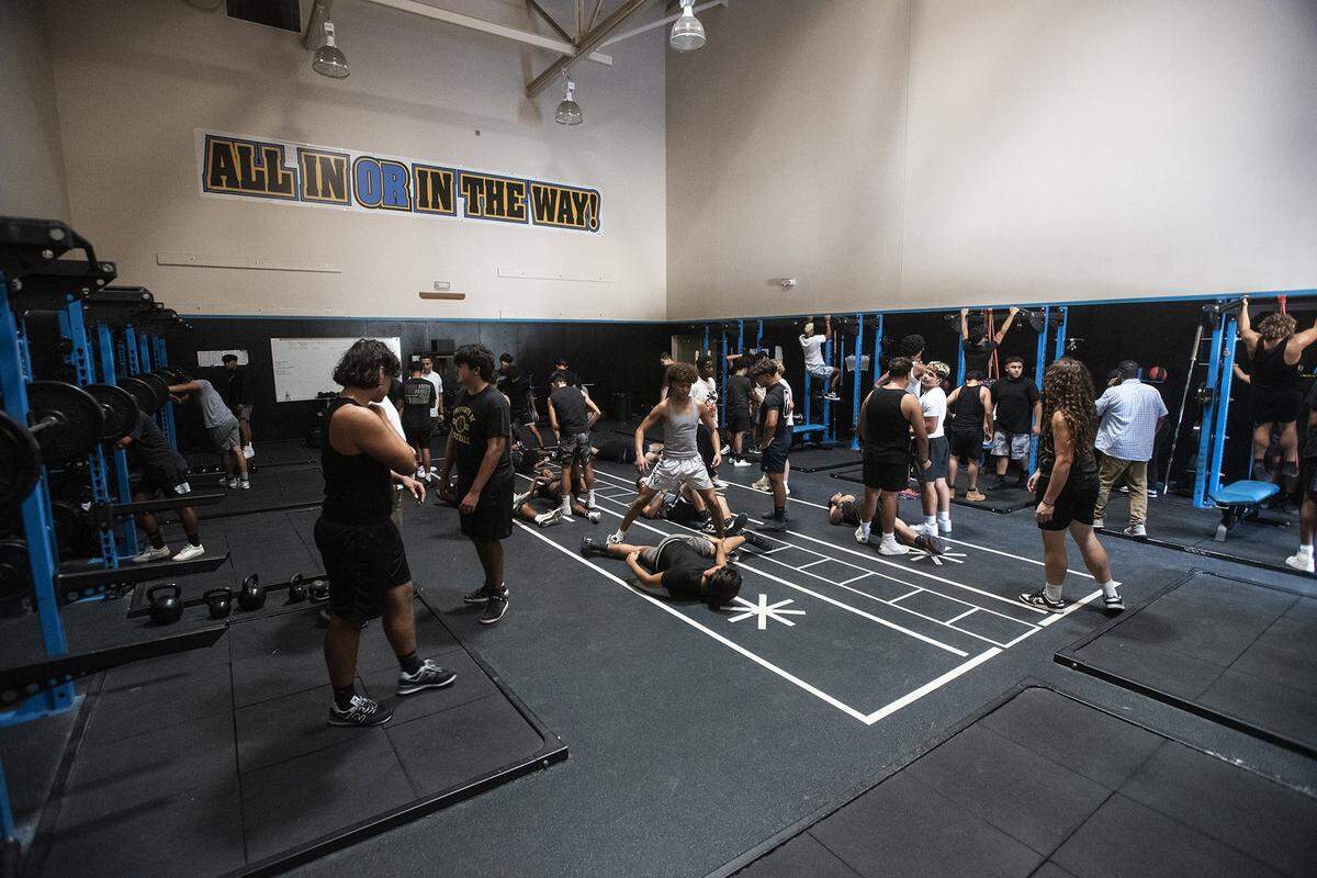 The El Capitan football team works out prior to taking the field for practice at El Capitan High School in Merced, Calif., on Thursday, Sept. 5, 2024.