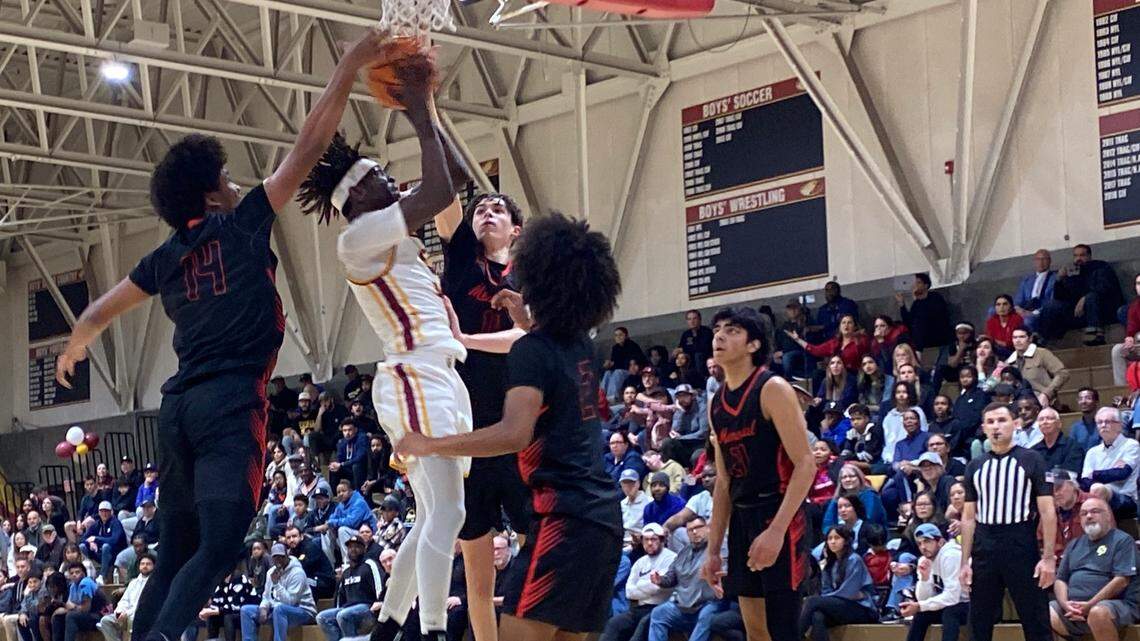 Clovis West’s DJ Stickman is defended by several San Joaquin Memorial players during its Central Section Division I quarterfinal game on Thursday, Feb. 15, 2024.