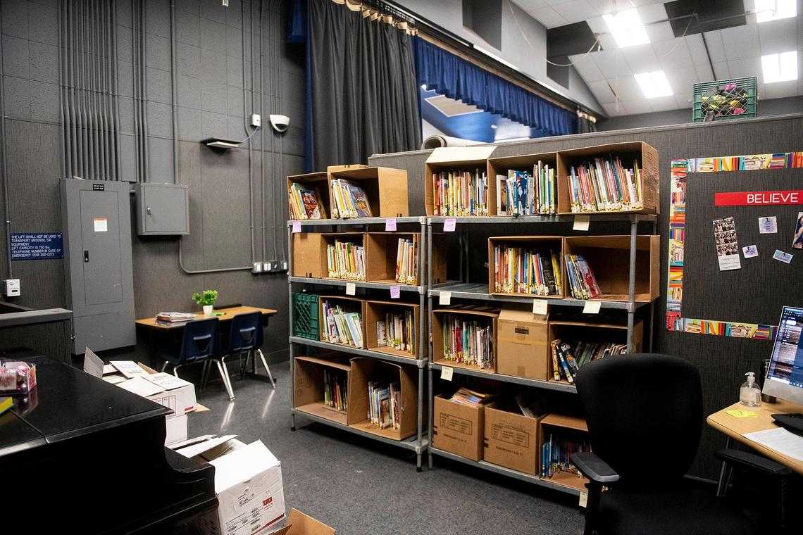 The stage and wing area serve as a temporary library at Planada Elementary School in Planada, Calif., on Wednesday, Feb. 8, 2023. Many classrooms and buildings at the school as well as homes and businesses throughout the community were damaged by January flooding which forced thousands to evacuate the town.