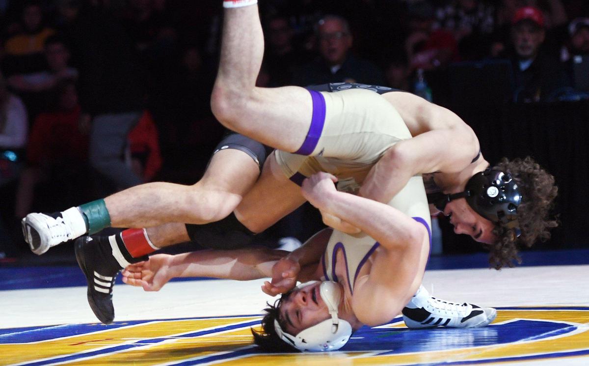Clovis North’s Joey Cruz, background, slams Righetti’s Dominic Mendeto the mat in the 113lb bout at the CIF state wrestling championships held Sarurday, Feb. 26, 2022 in Bakerfield. Cruz went on to win 8-3.