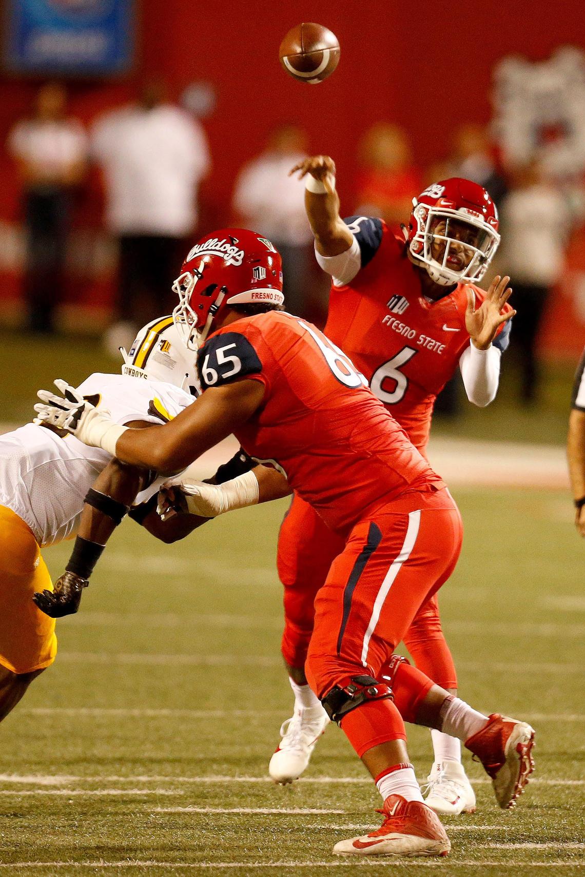 Fresno State right tackle Syrus Tuitele (65) fends off a Wyoming pass rusher charging at quarterback Marcus McMaryion last season. Tuitele is one of only two Bulldogs’ offensive linemen with more than one career start heading into the 2019 season.