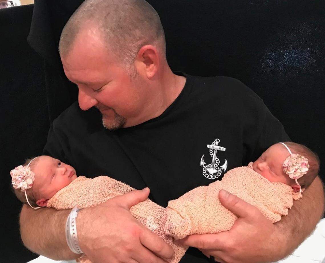 Fresno County firefighter Nick Reeder holds his newborn twin girls, Kaia Lyn and Kelce Jo.