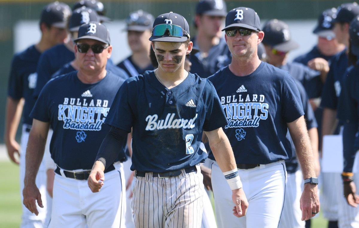 Bullard’s Beckett Zavorek, center, walks off the field with the team after the Knights defeated the Edison Tigers 2-0 in a County/Metro Athletic Conference baseball game Saturday, March 26, 2022 in Fresno.